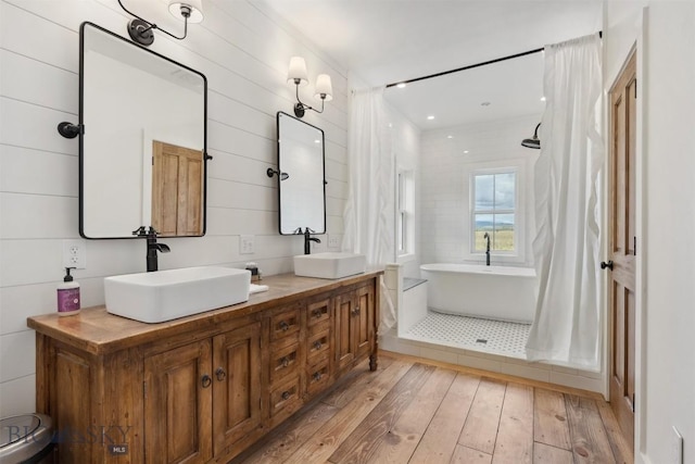 992 Deer Haven Dr, Deer Lodge, MT 59722 - bathroom featuring hardwood / wood-style floors, a soaking tub, and double vanity