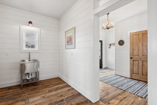 992 Deer Haven Dr, Deer Lodge, MT 59722 - corridor with dark wood-type flooring, a chandelier, and wood walls