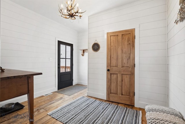 992 Deer Haven Dr, Deer Lodge, MT 59722 - foyer entrance featuring a chandelier, wood-type flooring, and baseboards