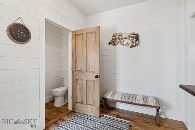 992 Deer Haven Dr, Deer Lodge, MT 59722 - bathroom with toilet, wood finished floors, crown molding, and wood walls