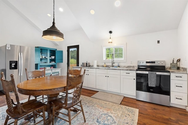 992 Deer Haven Dr, Deer Lodge, MT 59722 - kitchen with stainless steel appliances, vaulted ceiling, a sink, dark wood-style flooring, and white cabinetry