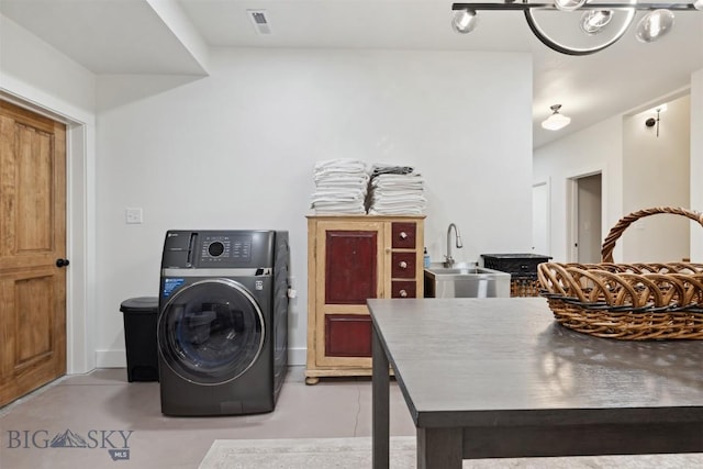 992 Deer Haven Dr, Deer Lodge, MT 59722 - laundry room with a sink, washer / dryer, and a chandelier