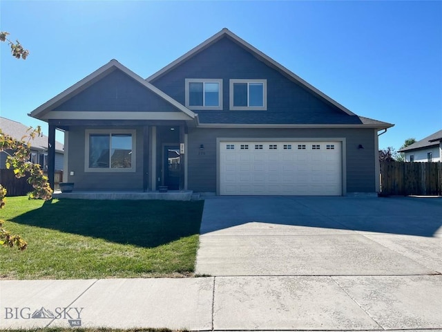 view of front of home featuring a front lawn, fence, an attached garage, and concrete driveway