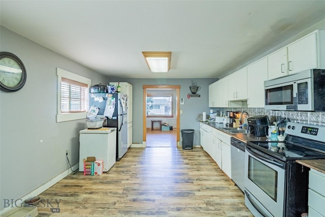 1916 S Jackson, Butte, MT 59701 - kitchen with a wealth of natural light, white cabinets, a sink, and appliances with stainless steel finishes
