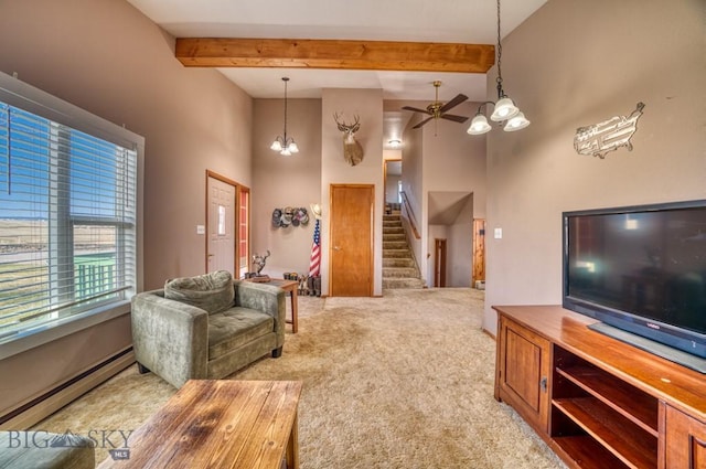5585 W Cameron Bridge Rd, Manhattan, MT 59741 - living room featuring a baseboard heating unit, stairs, a high ceiling, light colored carpet, and ceiling fan