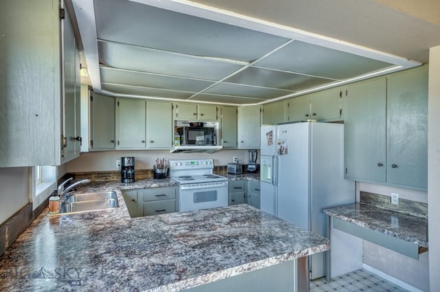 5585 W Cameron Bridge Rd, Manhattan, MT 59741 - kitchen with white appliances, a peninsula, and green cabinets