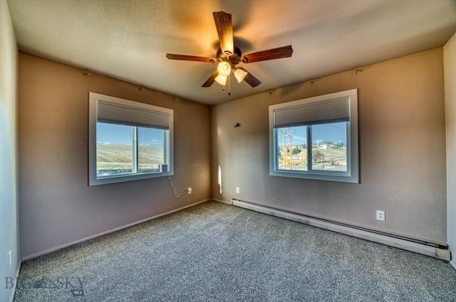 5585 W Cameron Bridge Rd, Manhattan, MT 59741 - carpeted spare room featuring baseboard heating, healthy amount of natural light, and a ceiling fan