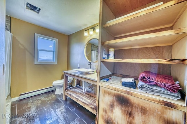 5585 W Cameron Bridge Rd, Manhattan, MT 59741 - bathroom with a baseboard heating unit, vanity, and stone finish flooring