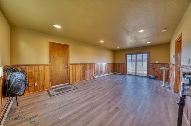 5585 W Cameron Bridge Rd, Manhattan, MT 59741 - empty room featuring wainscoting, wood finished floors, recessed lighting, and baseboard heating