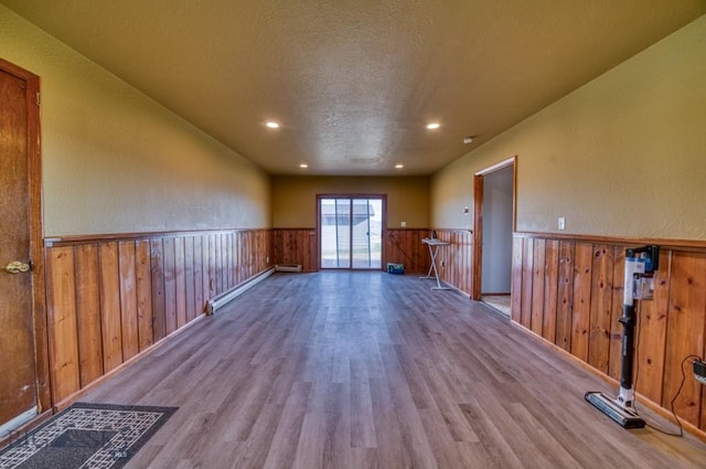 5585 W Cameron Bridge Rd, Manhattan, MT 59741 - empty room featuring a wainscoted wall, wood finished floors, recessed lighting, and baseboard heating