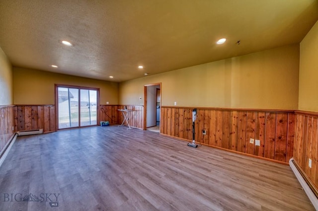 5585 W Cameron Bridge Rd, Manhattan, MT 59741 - spare room with a wainscoted wall, a baseboard heating unit, wood finished floors, recessed lighting, and a baseboard radiator