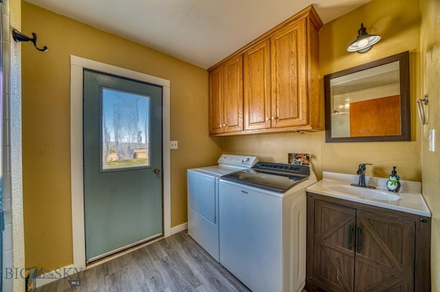 5585 W Cameron Bridge Rd, Manhattan, MT 59741 - washroom featuring cabinet space, separate washer and dryer, and wood finished floors