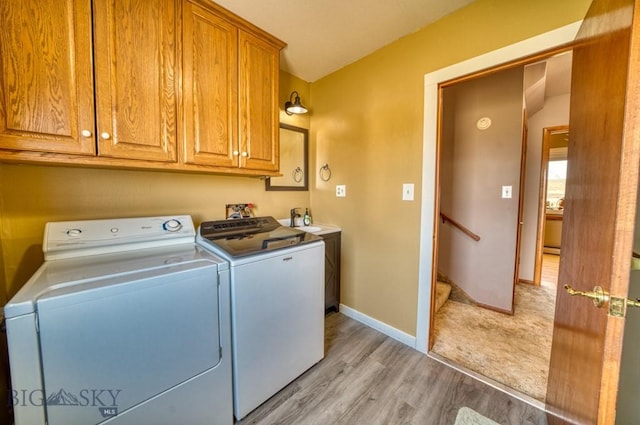 5585 W Cameron Bridge Rd, Manhattan, MT 59741 - laundry room with cabinet space, separate washer and dryer, and light wood-style flooring