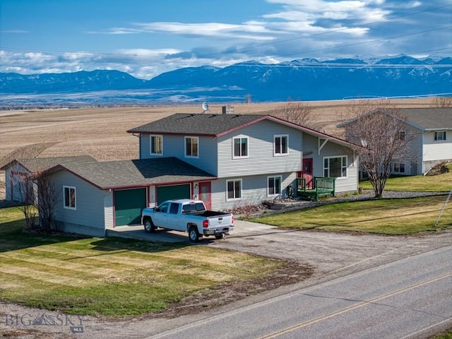 5585 W Cameron Bridge Rd, Manhattan, MT 59741 - view of front of property with a mountain view, driveway, a garage, and a front lawn
