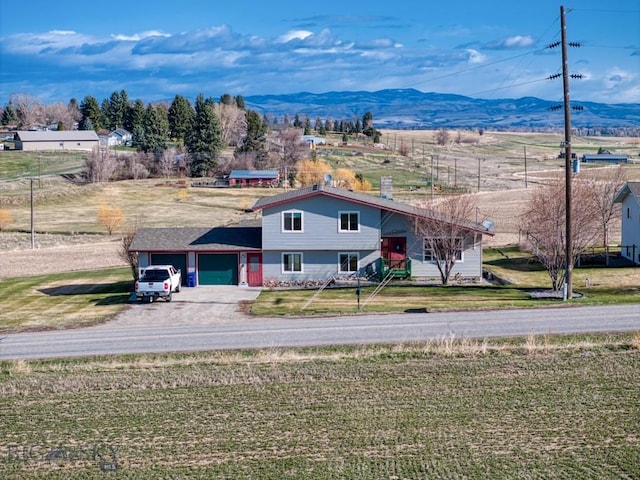 5585 W Cameron Bridge Rd, Manhattan, MT 59741 - view of front of property featuring a garage, a mountain view, driveway, and a front yard
