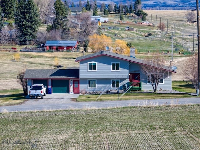5585 W Cameron Bridge Rd, Manhattan, MT 59741 - view of front of house featuring an attached garage, a front lawn, concrete driveway, and a rural view