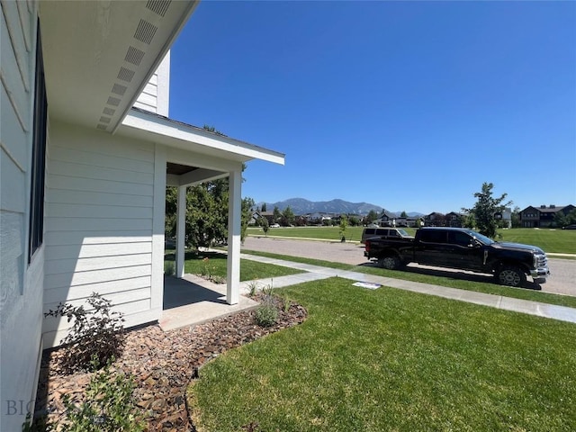 1033 N 14th, Bozeman, MT 59715 - view of green lawn with a mountain view and covered porch