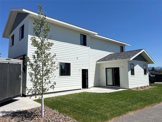 1033 N 14th, Bozeman, MT 59715 - back of property featuring a patio area, a lawn, and a shingled roof