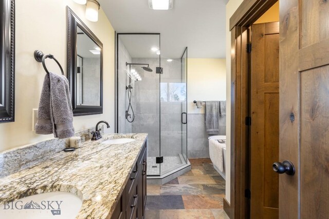 9 Cedar Ct, Ennis, MT 59751 - bathroom with a stall shower, double vanity, and stone finish flooring
