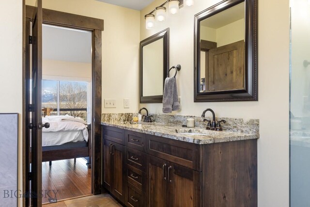 9 Cedar Ct, Ennis, MT 59751 - full bath featuring double vanity, connected bathroom, and wood finished floors