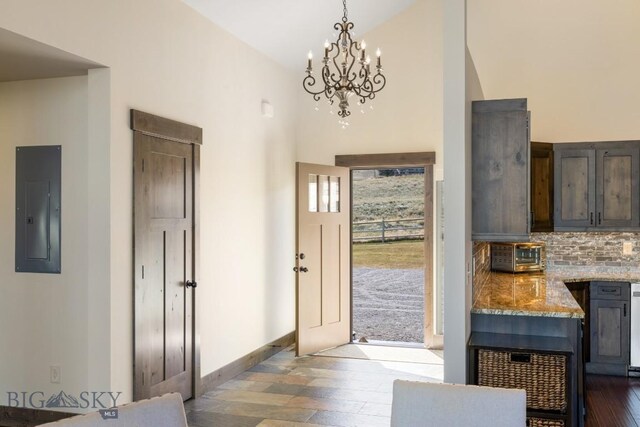 9 Cedar Ct, Ennis, MT 59751 - foyer with electric panel, a chandelier, dark wood-type flooring, and high vaulted ceiling