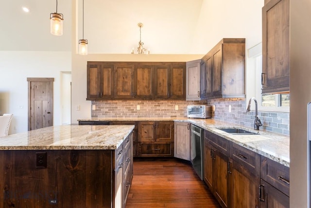 9 Cedar Ct, Ennis, MT 59751 - kitchen with dark wood-style flooring, backsplash, a kitchen island, dishwasher, and high vaulted ceiling