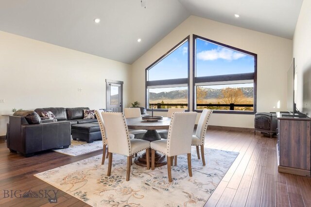 9 Cedar Ct, Ennis, MT 59751 - dining room featuring a wood stove, high vaulted ceiling, and wood-type flooring
