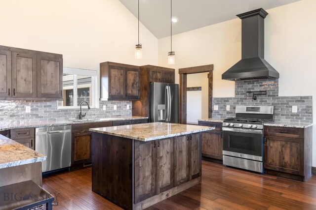 9 Cedar Ct, Ennis, MT 59751 - kitchen with stainless steel appliances, wall chimney range hood, high vaulted ceiling, tasteful backsplash, and dark wood-type flooring