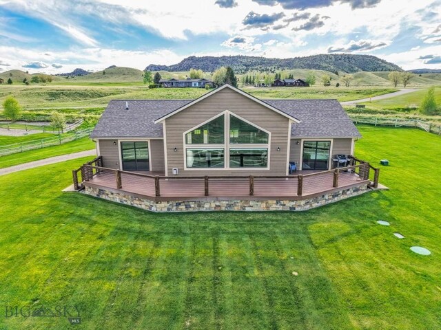 9 Cedar Ct, Ennis, MT 59751 - rear view of house featuring a deck with mountain view, a shingled roof, and a view of countryside