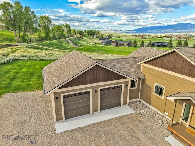 9 Cedar Ct, Ennis, MT 59751 - view of front of home with a shingled roof, a mountain view, a garage, and driveway