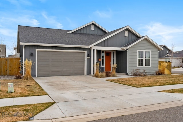 view of front of house featuring board and batten siding, driveway, fence, an attached garage, and a shingled roof
