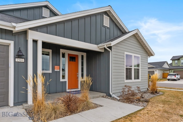 view of front of home featuring covered porch, board and batten siding, and a garage