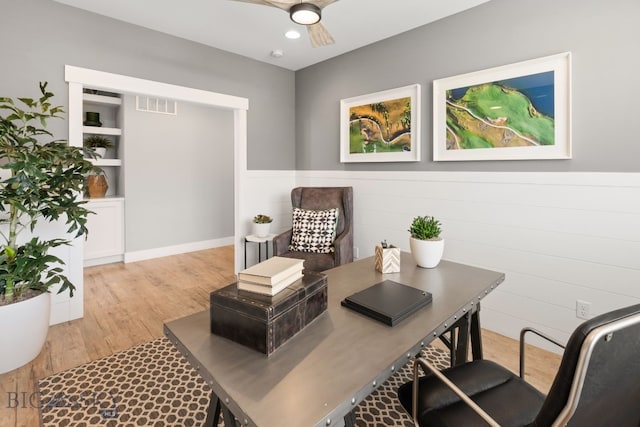interior space featuring visible vents, wood finished floors, and a ceiling fan