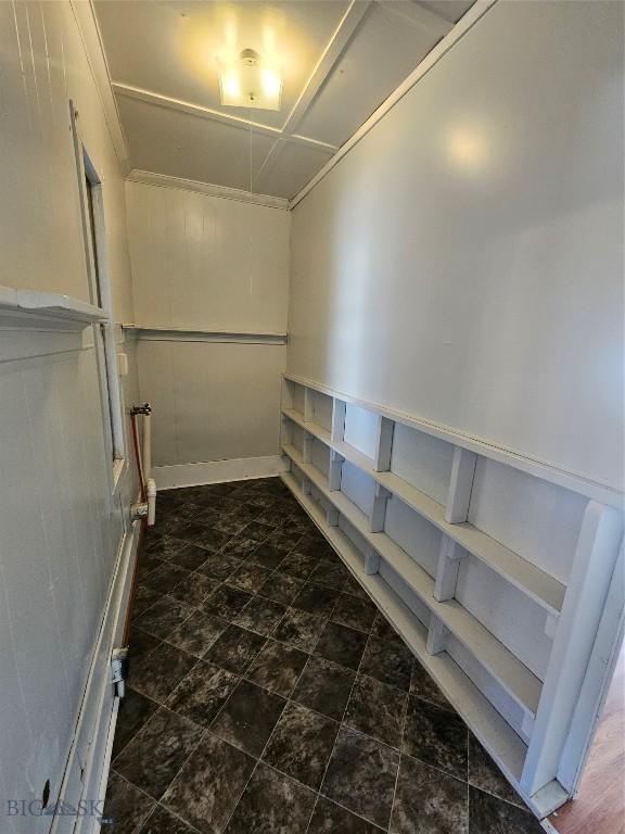 spacious closet featuring stone finish flooring
