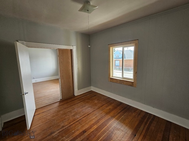 interior space with baseboards and dark wood-style flooring