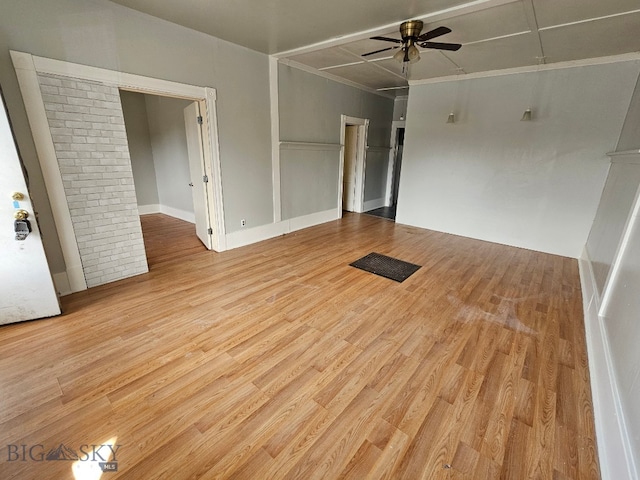 empty room featuring visible vents, wood finished floors, and a ceiling fan