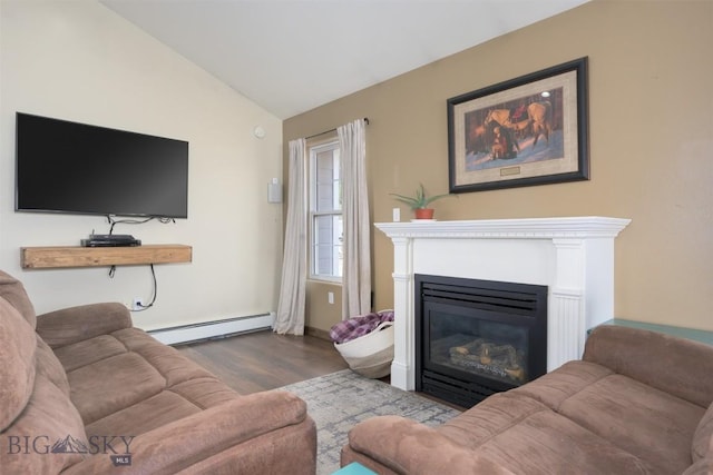 living area with a glass covered fireplace, lofted ceiling, a baseboard radiator, and wood finished floors