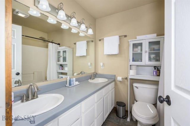 bathroom with double vanity, a shower with curtain, a sink, and toilet