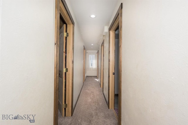 hall with recessed lighting and carpet flooring