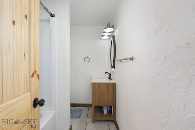 bathroom with tile patterned flooring, vanity, and baseboards