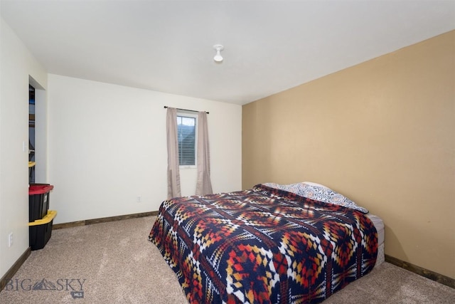 carpeted bedroom featuring baseboards