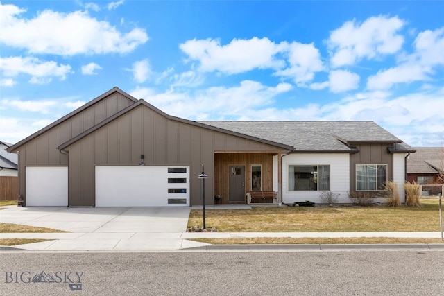 1308 Scooter Ln, Belgrade, MT 59714 - view of front of home with board and batten siding, a front lawn, and an attached garage