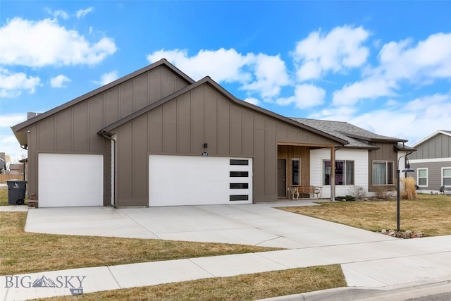 1308 Scooter Ln, Belgrade, MT 59714 - view of front of house featuring board and batten siding, a garage, driveway, and a front yard