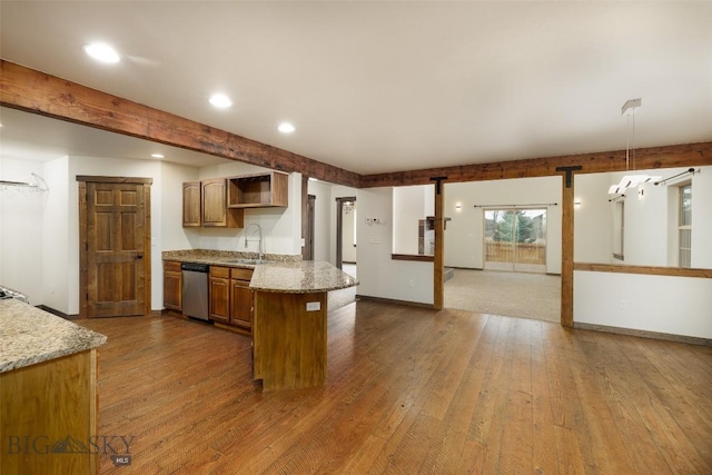 kitchen featuring a peninsula, recessed lighting, a sink, and hardwood / wood-style flooring