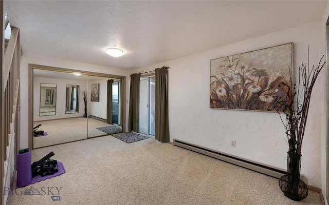 interior space with baseboard heating and carpet