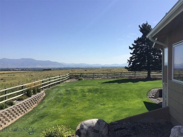 view of yard featuring a mountain view, fence private yard, and a rural view