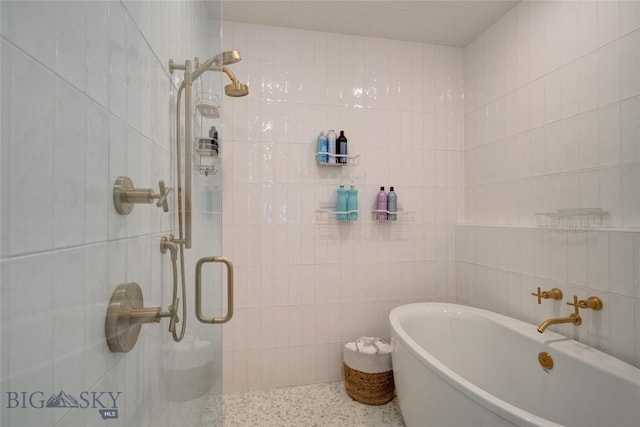 280 High Ridge Rd, Bozeman, MT 59715 - bathroom with speckled floor, tile walls, a shower stall, and a freestanding bath