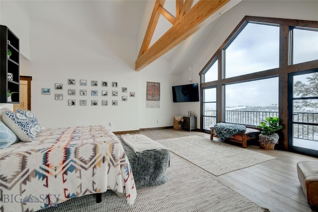 280 High Ridge Rd, Bozeman, MT 59715 - bedroom featuring high vaulted ceiling, access to exterior, beamed ceiling, and wood finished floors