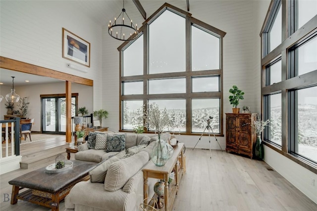 280 High Ridge Rd, Bozeman, MT 59715 - living area with a chandelier, plenty of natural light, light wood-style flooring, and a high ceiling