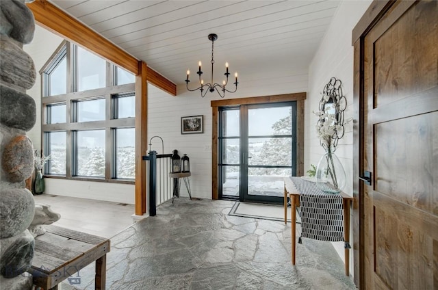 280 High Ridge Rd, Bozeman, MT 59715 - foyer with stone floors, a chandelier, wooden walls, and a healthy amount of sunlight